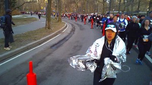 Christine runs with her mylar blanket about mile 2
