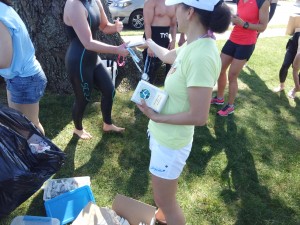 Volunter (Christine) gives awards to top 10 finishers