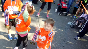 kid volunteers giving out medals