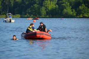 distressed swimmer gets fished out of the lake by water safety